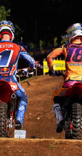 Chase Sexton and Jett Lawrence sitting side by side at the starting gate wearing full Alpinestars MX26 gear sets and Mx boots — motocross pros in the latest dirt bike gear.
