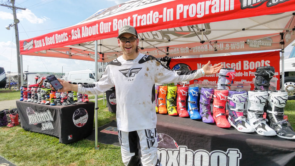 Boot Specialist Sam standing in front of the MxBoot trackside setup
