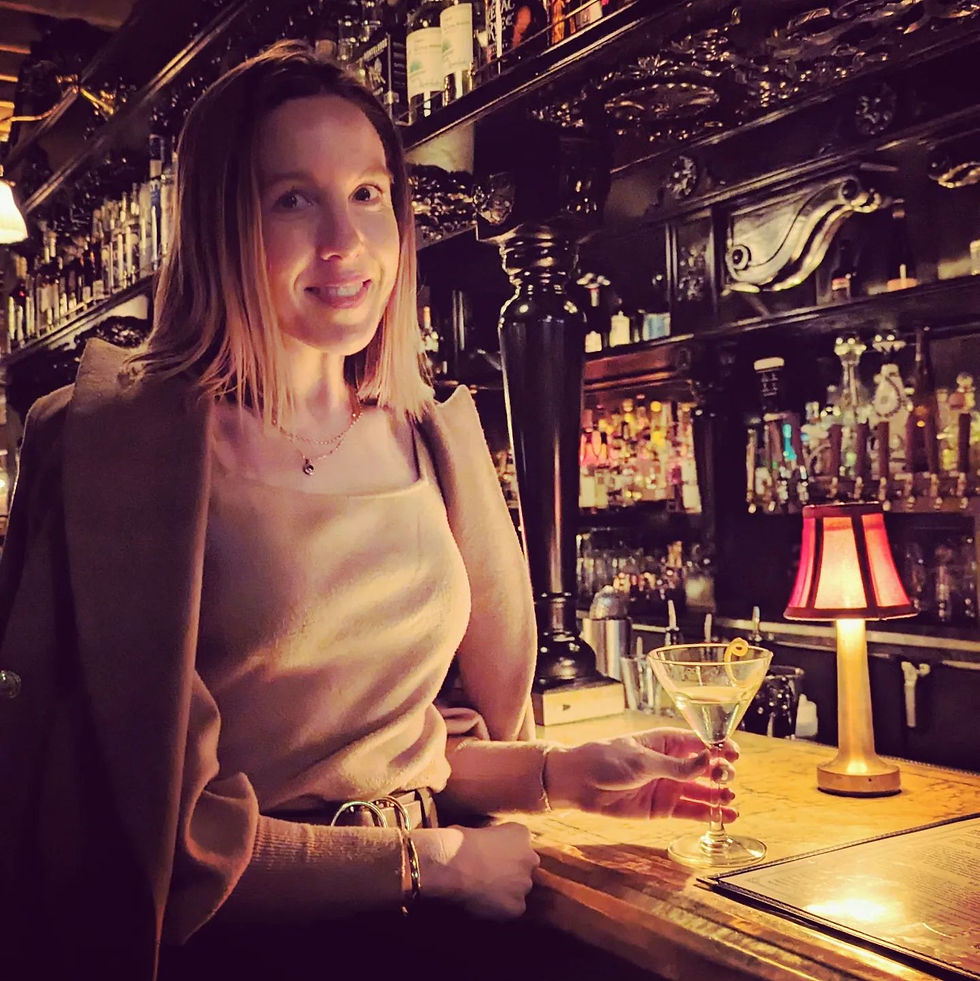 woman holding a martini at a cocktail bar