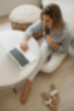 woman sitting down lookin at her computer