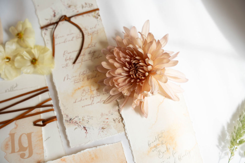 wedding stationary with flower placed beside it 