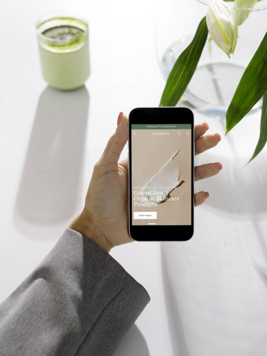 Hand holding smartphone displaying a webpage