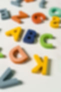 Colorful wooden alphabet letters spelling out early letter sounds and literacy skills