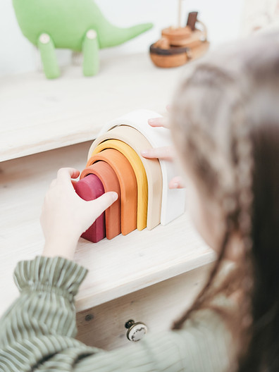 Young child building fine-motor and language skills with a stacking toy — bilingual speech therapy in Sahuarita, AZ