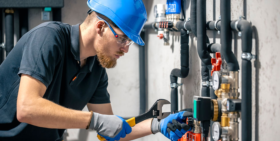 man-installs-heating-system-house-checks-pipes-with-wrench.jpg