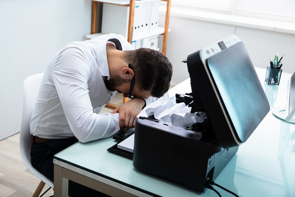 Man frustrated by broken printer