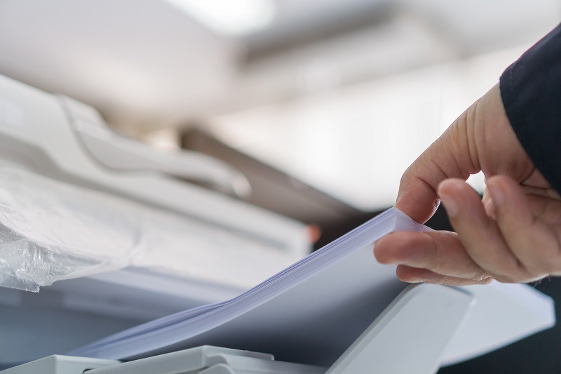 Someone Adding Papers into Copying Machine