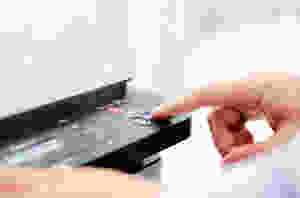 Finger pressing button on copy machine