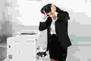 Businesswoman frustrated with copy machine