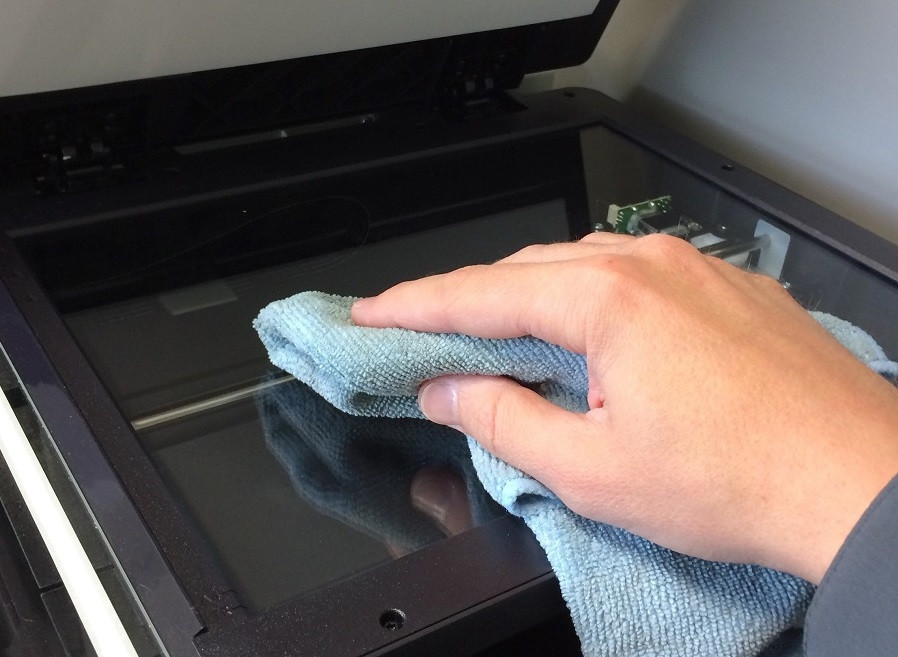 Person Cleaning Copier Machine