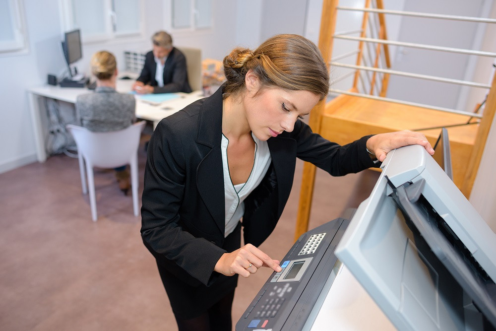 Businesswoman making copies on copier