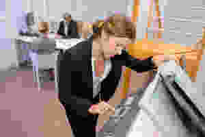 Businesswoman making copies on copier