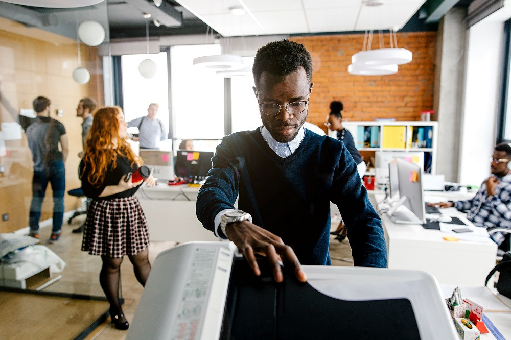 Man Using Copier in Office