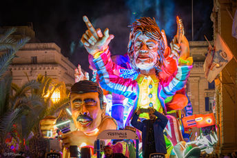 Night parade float with rock star figure and 'FESTIVALS MALTA' sign