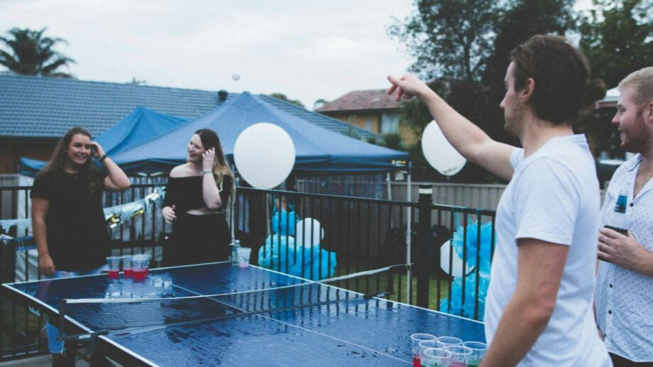 best drinking games - young people playing beer pong outside