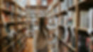 Woman browsing books in a library - student finance payment dates