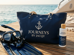 Snorkel gear, navy beach tote reading JOURNEYS BY JACQY, and Ocean Botanics SPF 50+ on a boat deck by the sea.