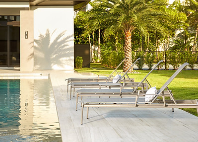 Brown Jordan lounge chairs by a pool