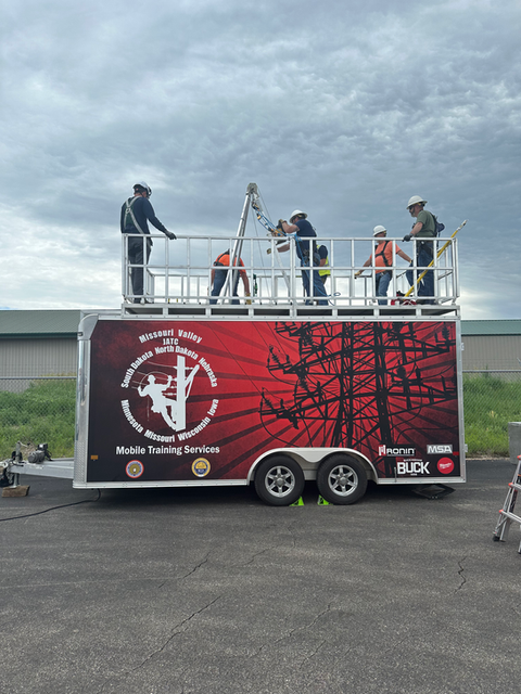 Mobile trailer with a group of people standing on top