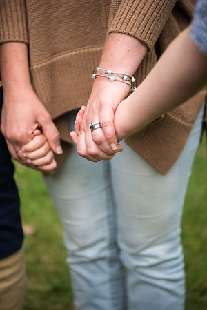 woman holding children's hands