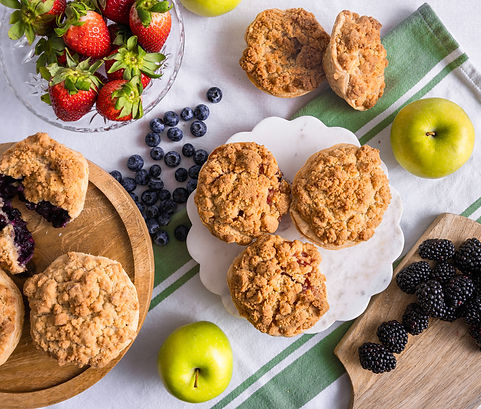 Decorative table spread of mini pies and fruit