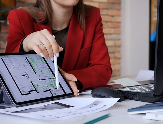 Team shows apartment layout to client on sleek tablet screen. Woman architect navigates th