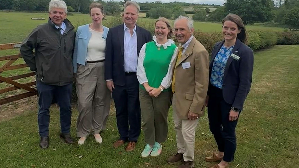 5 members of the CLA stood outside a farm gate smiling.