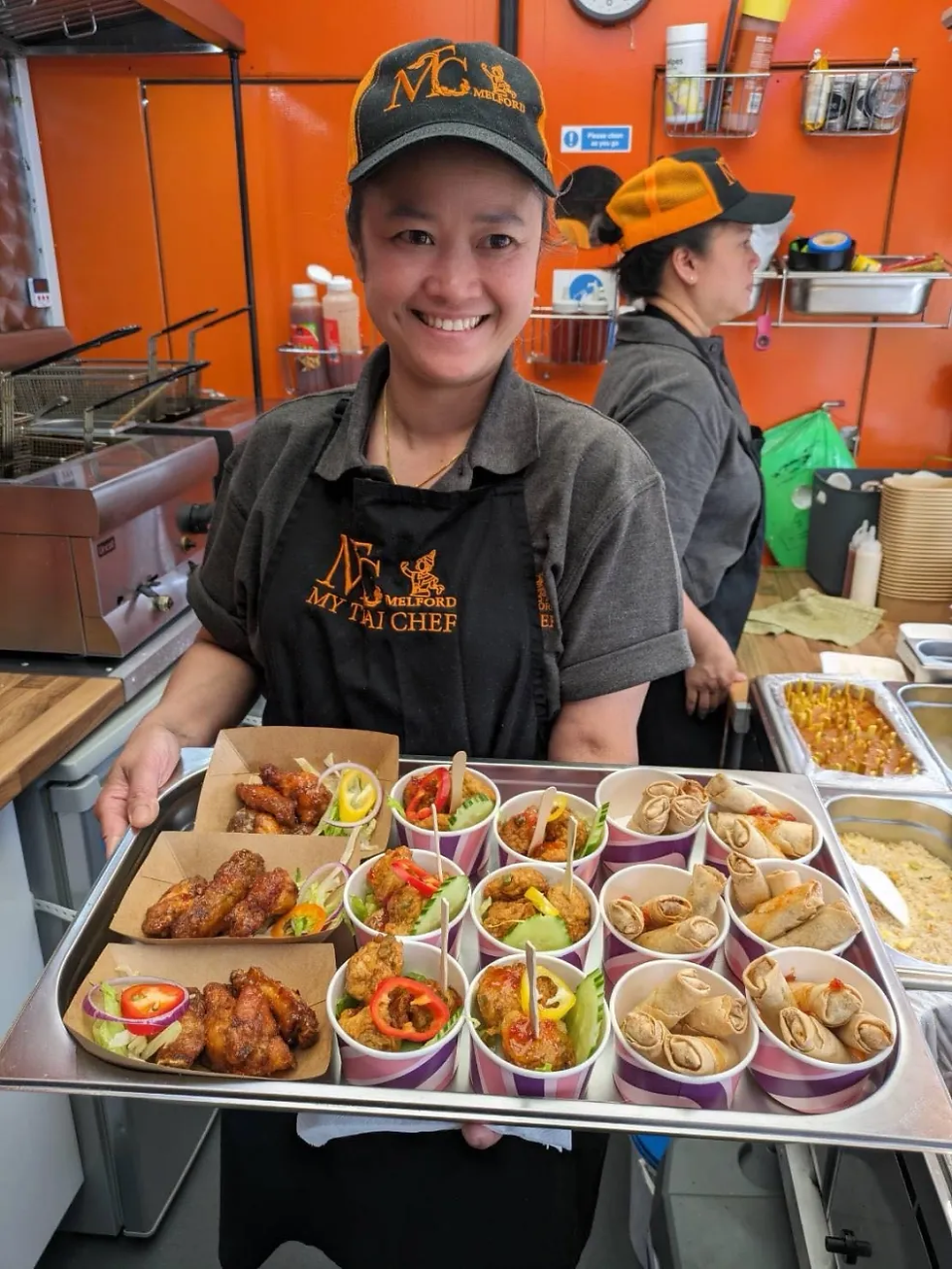 Waitress serving tray of thai food