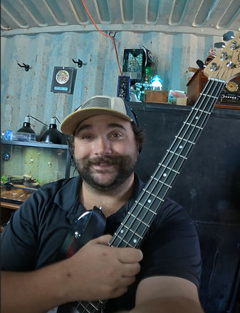 MadLadGibson musician Ryan Gibson holding a bass guitar