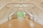 a-large-white-attic-room-with-wooden-floors-and-wi-2023-11-27-05-07-55-utc.jpg