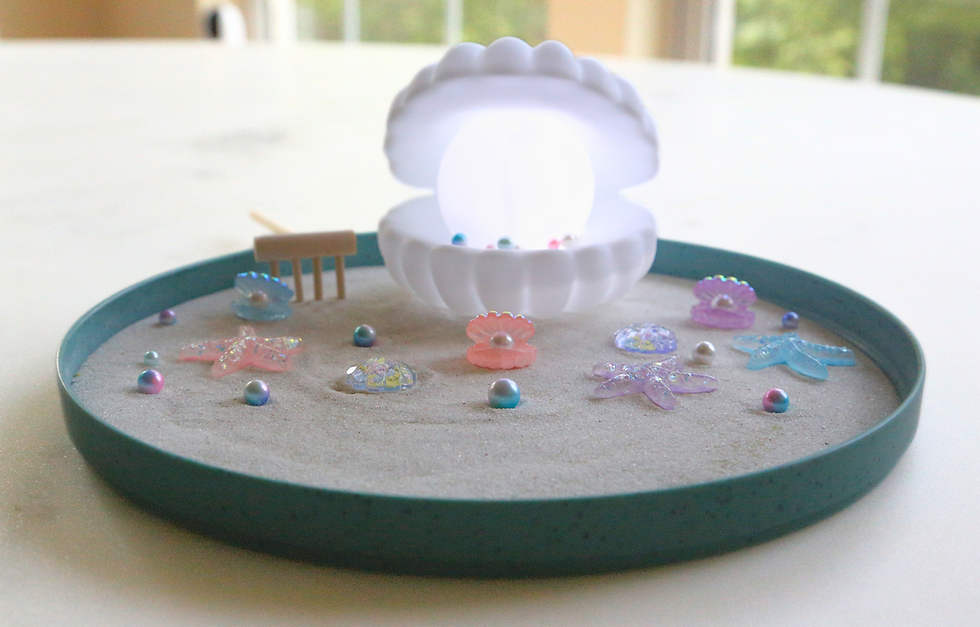 Thumbnail: Miniature zen garden with pearl-lit seashell