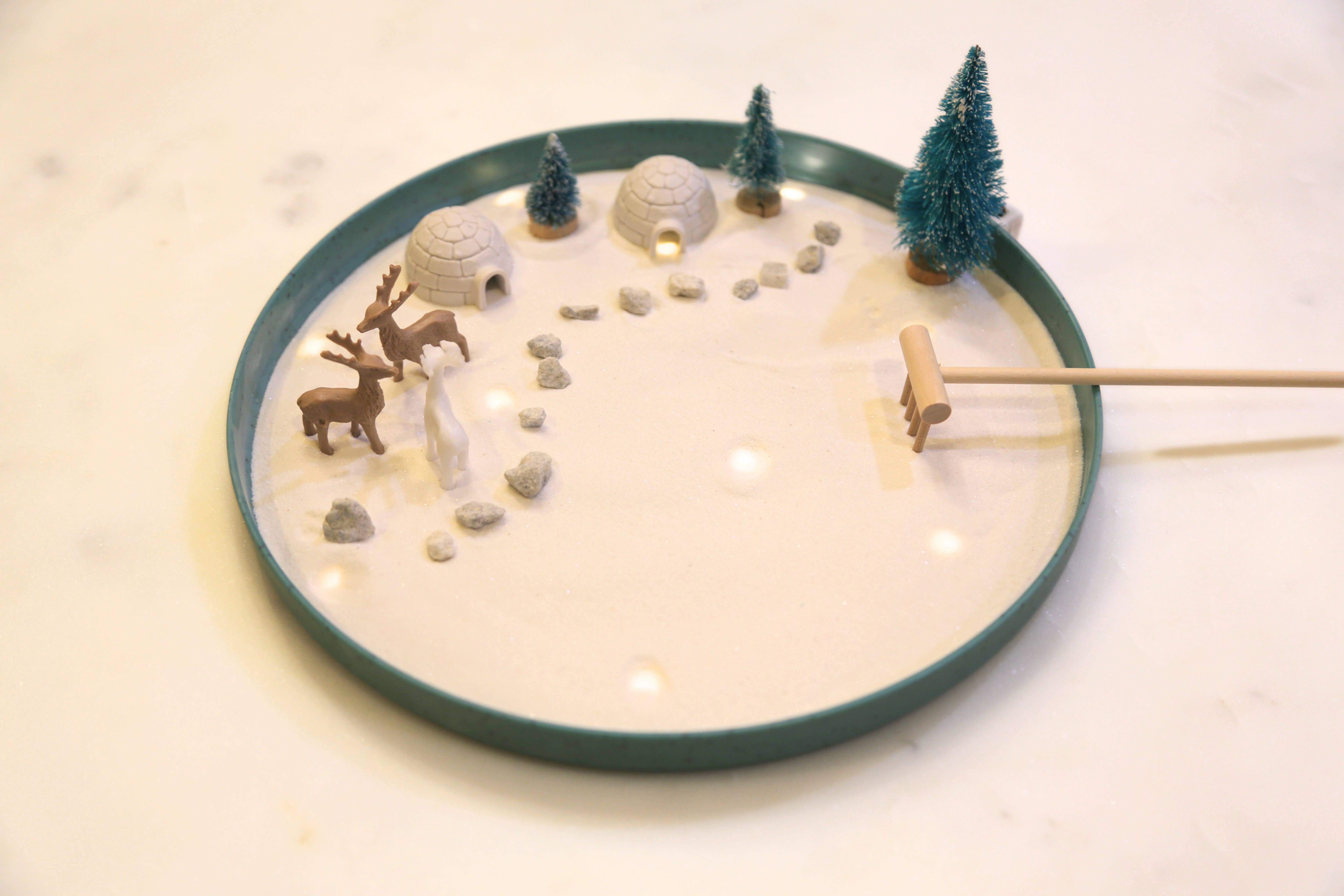 Miniature winter zen garden with deer