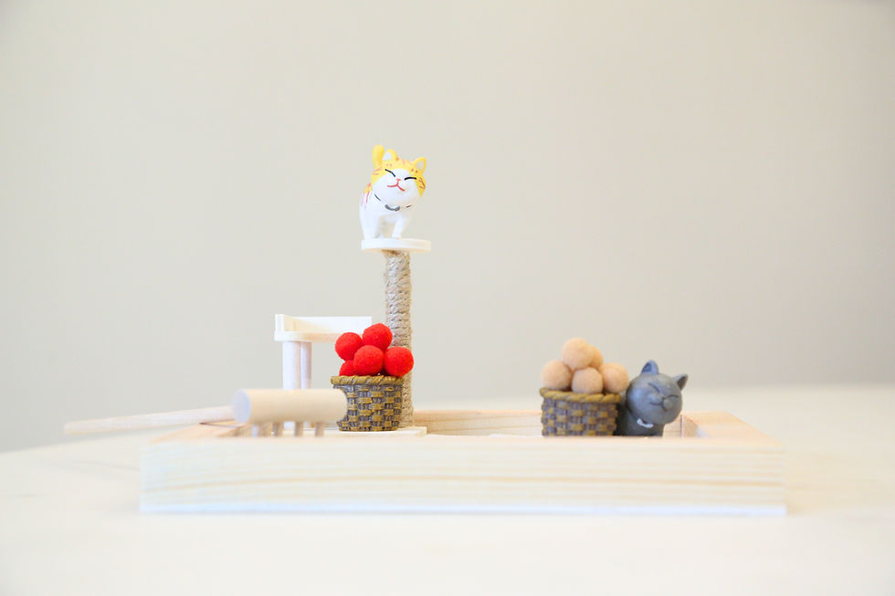 Thumbnail: Miniature cat figurines with different poses and props on a flat surface