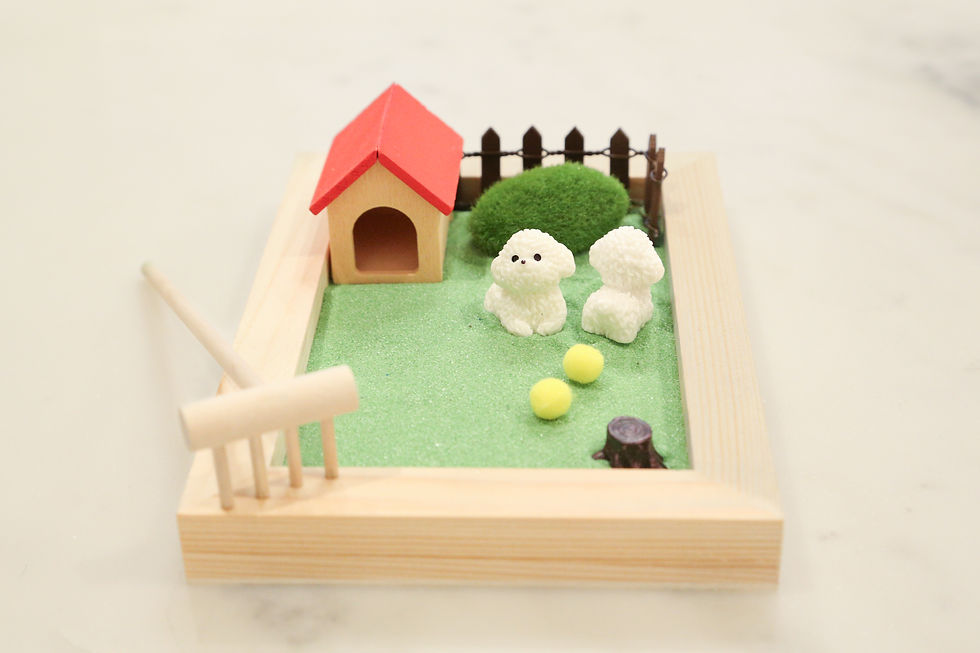 Thumbnail: Miniature dog house and dogs in a zen garden with rake and fence.