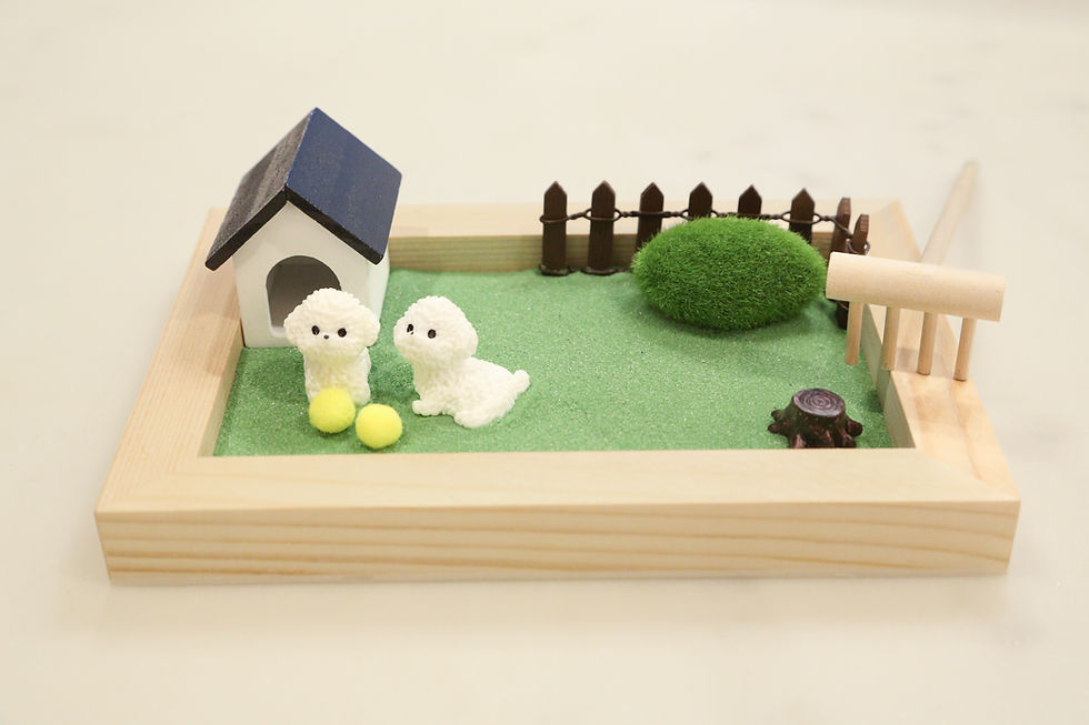 Thumbnail: Miniature dog figurines in their yard next to a dog house and fence.