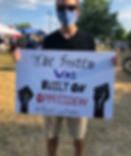 A sign that says "the system was built on oppression"