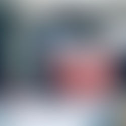 Figurine of a pink piggy bank with glasses and a pink miniature car on a table.