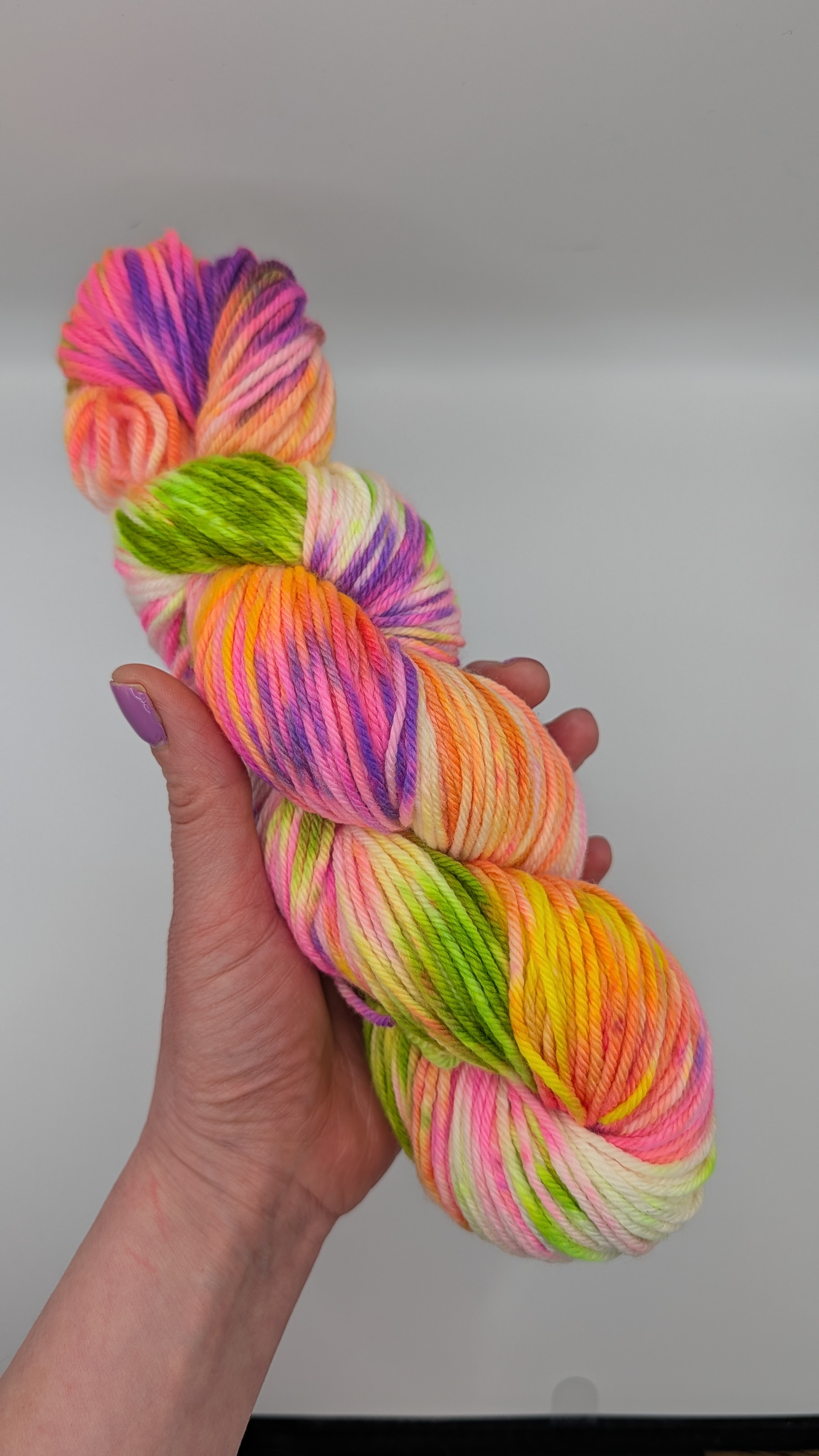 Hands actively crocheting a warm-weather shrug