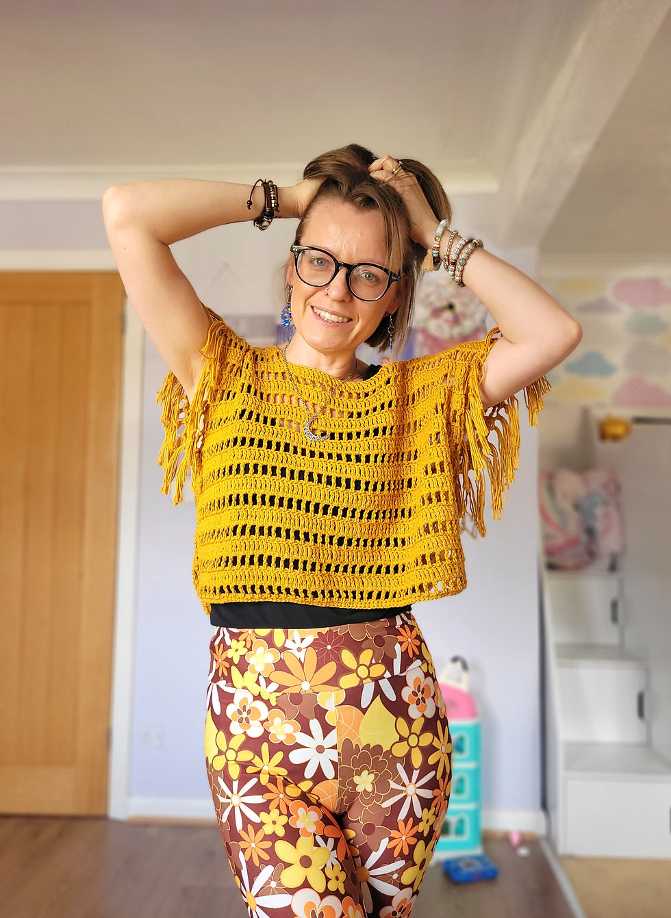 A girl posing in boho clothes and seventies style pants