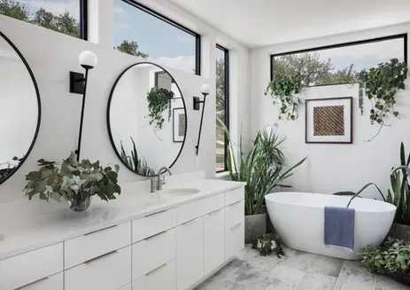 Modern bathroom with white vanity, round mirrors, tub, and plants