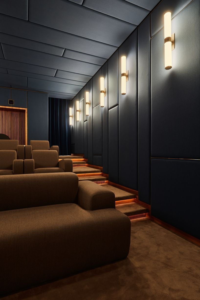 Luxury home theatre setup with premium recliner seating and acoustic wall panels in a modern interior, ideal for immersive Dolby Atmos experience in Hyderabad.

