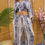 Thumbnail: Woman in stylish blue striped daydress