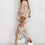 Thumbnail: Woman in beige velour tracksuit