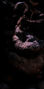 Psyduck is Petrified! by Roee Baldinger (Cerno Argus). High-contrast dark fine art photography of a rounded rock structure resembling the shocked Pokémon character frozen and shouting into the darkness. Part of the Psychosis of a Matter sub-series.