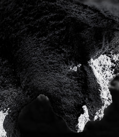 The Plague Doctor - Fine art pareidolia photography by Roee Baldinger. A natural rock formation resembling a masked plague doctor silhouette, emphasizing raw composition. Part of the Alone In Darkness series by Cerno Argus.