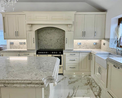 Luxury cream shaker kitchen with ornate detailing, marble worktops, farmhouse sink, and ce