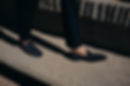 navy loafer shoes walking along concrete stairs