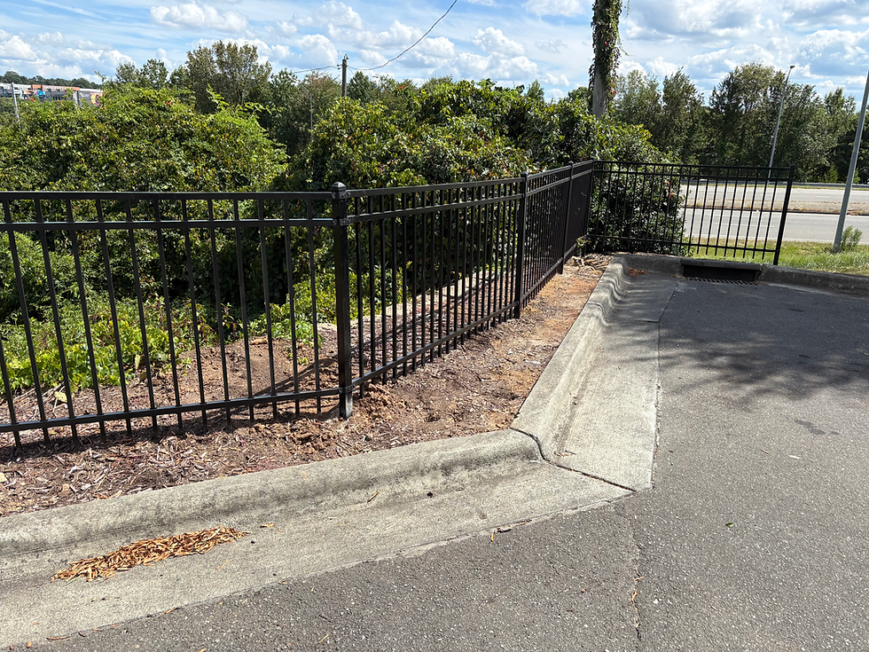 Repaired Black Aluminum Fence Along Curb