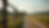 Eye-level view of wooden farm fence along a rural dirt road