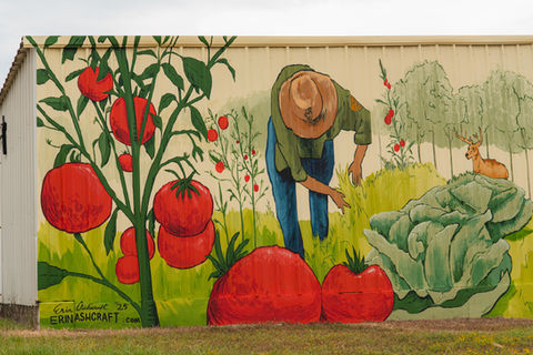 Mural of tomatoes and farmer with lettuce and trees